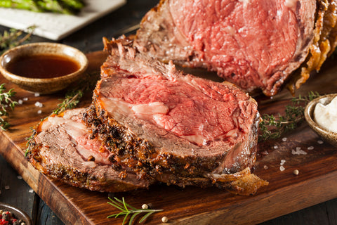 Medium rare, juice prime rib slices on cutting board