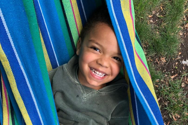 Boy sitting in a hammock 