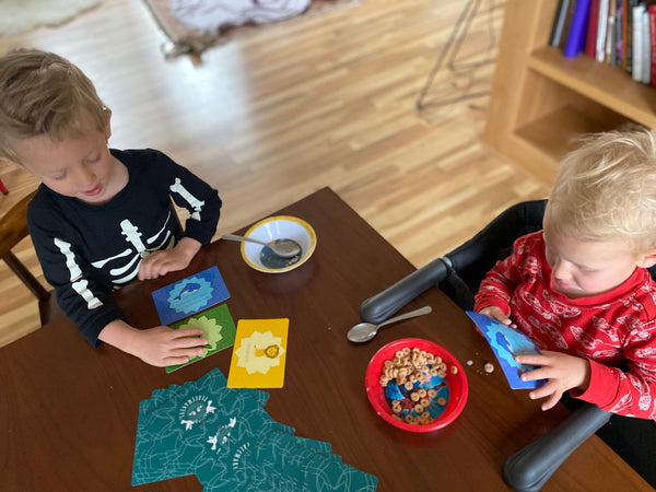 Children playing PeaceMakers cards