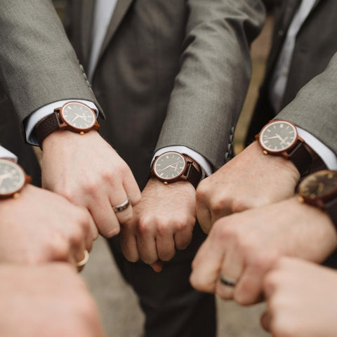 group of guys with hands showing watches in a circle 