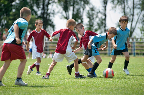 active kids playing soccer