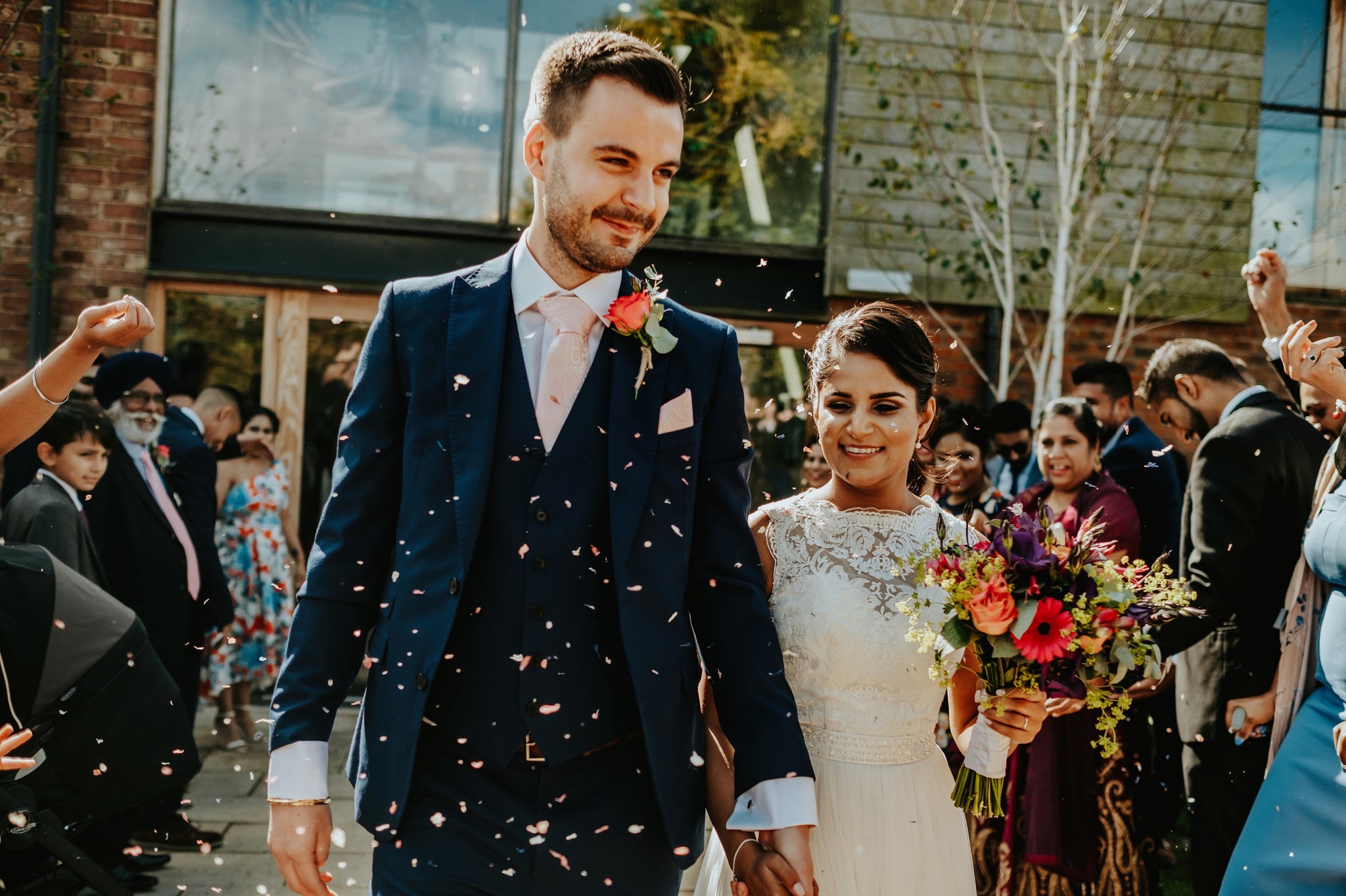 Bride and Groom with bright wedding flowers