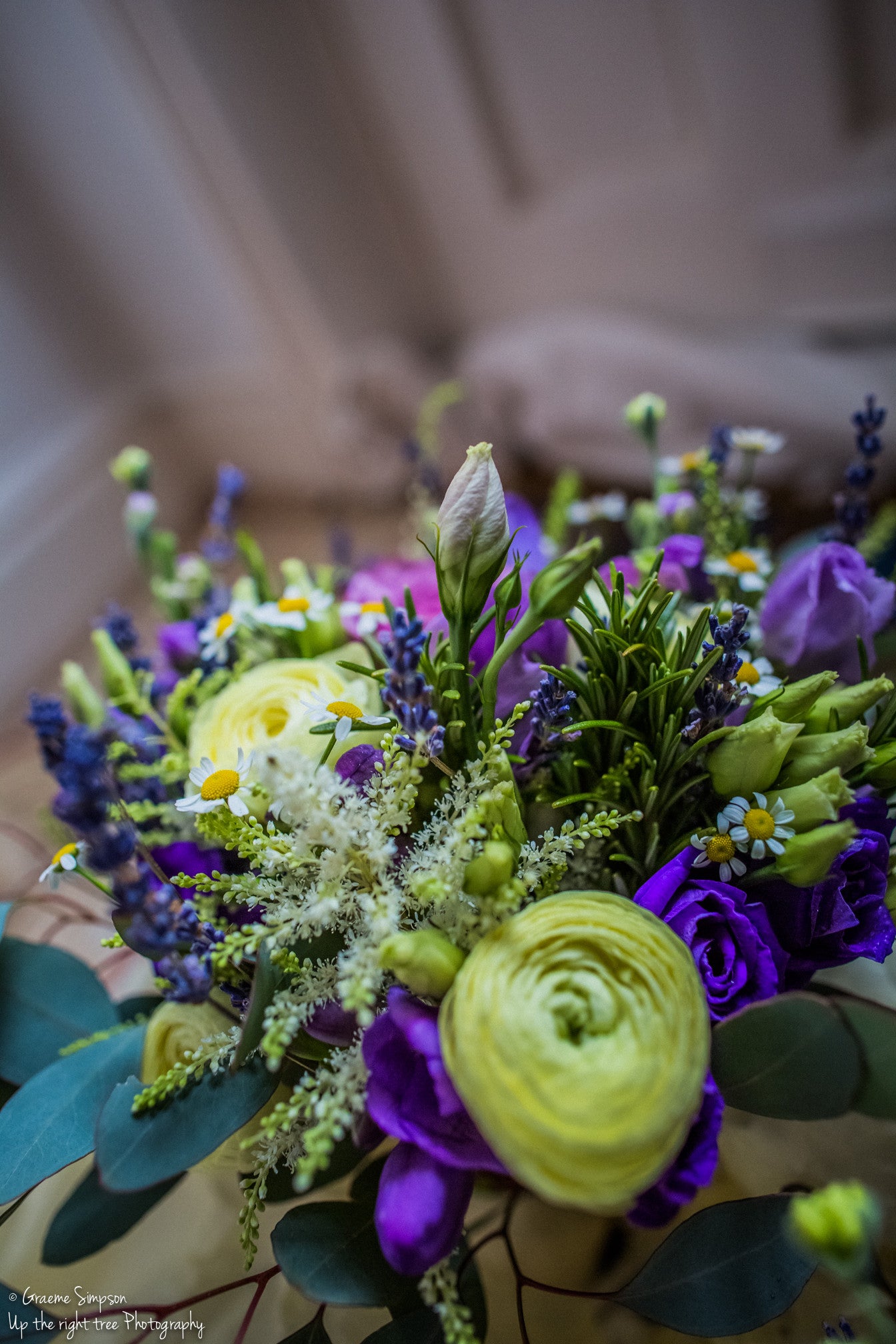 Classic hand tied bridal bouquet in cream and purple with Lisianthus and Daisies.