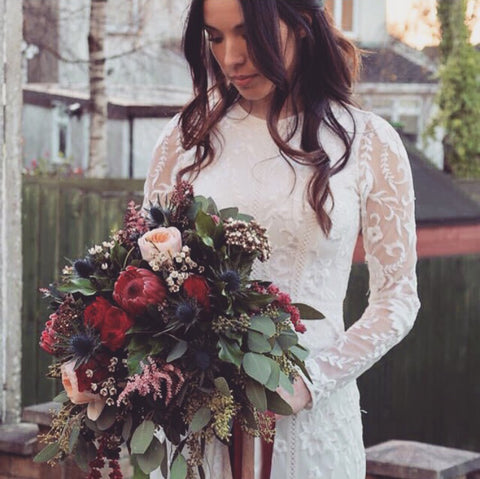 Bride holding wedding rose bouquet