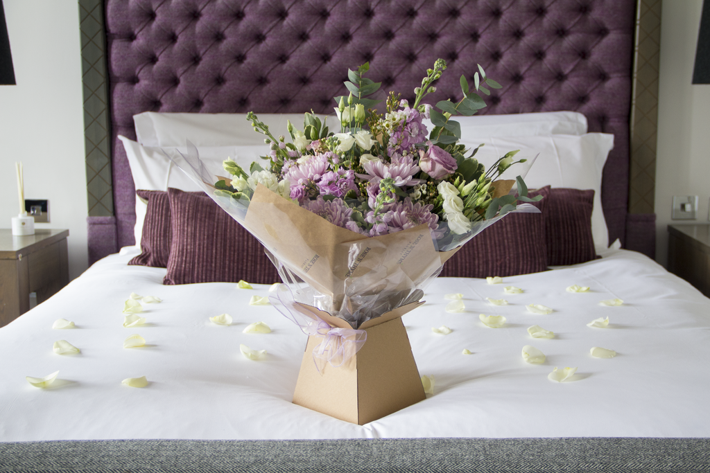Beautiful bouquet of Rose n Thyme Flowers on a bed in the Blythswood Hotel Glasgow
