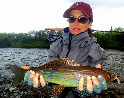Woman with nice arctic grayling taken on a fly