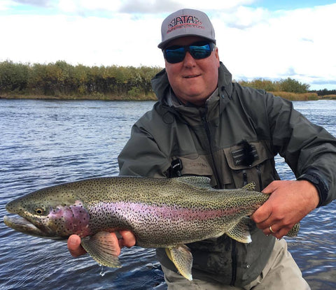 Proud ATA Lodge guest with large rainbow trout