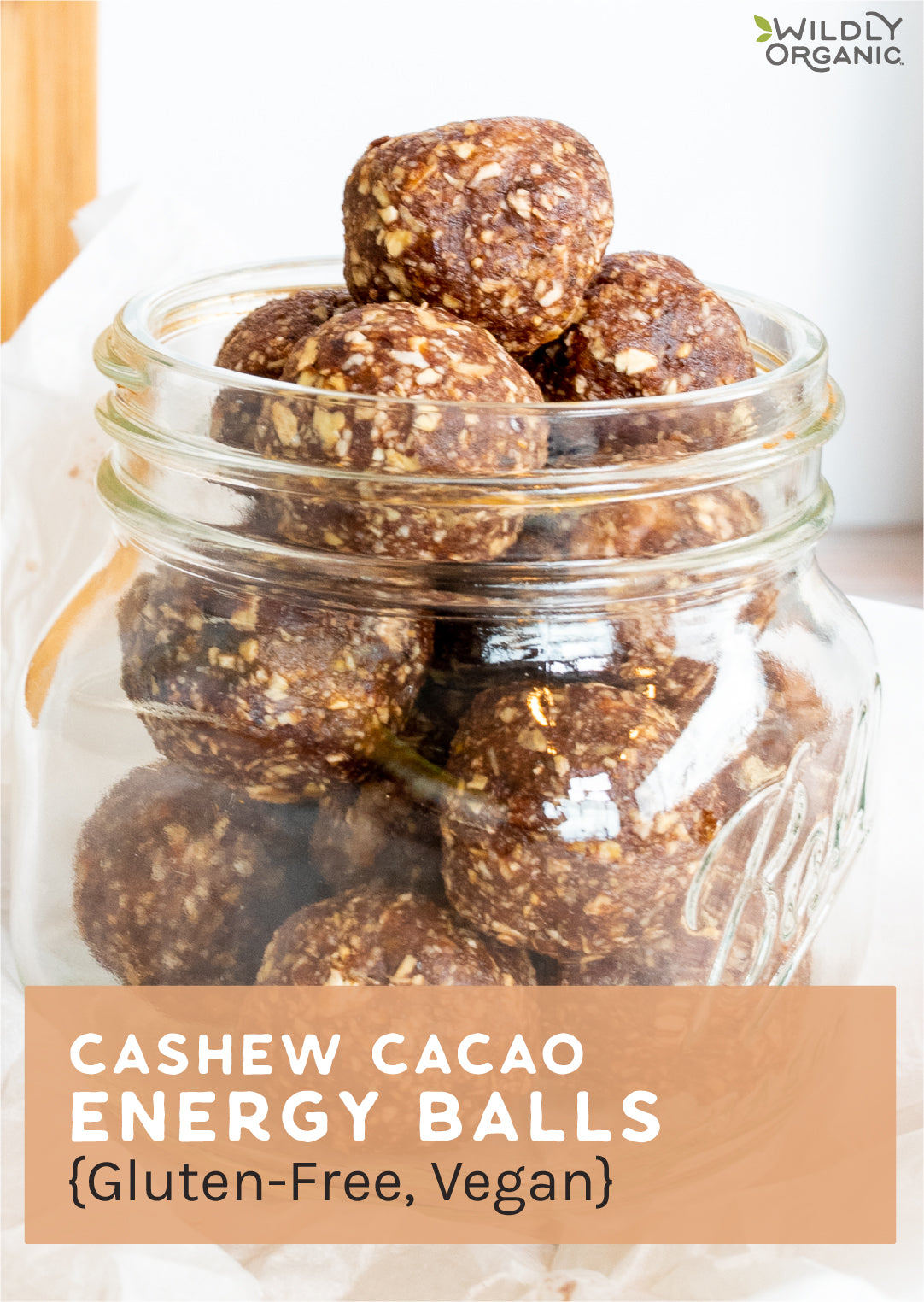 a stack of cashew cacao energy balls in a glass jar