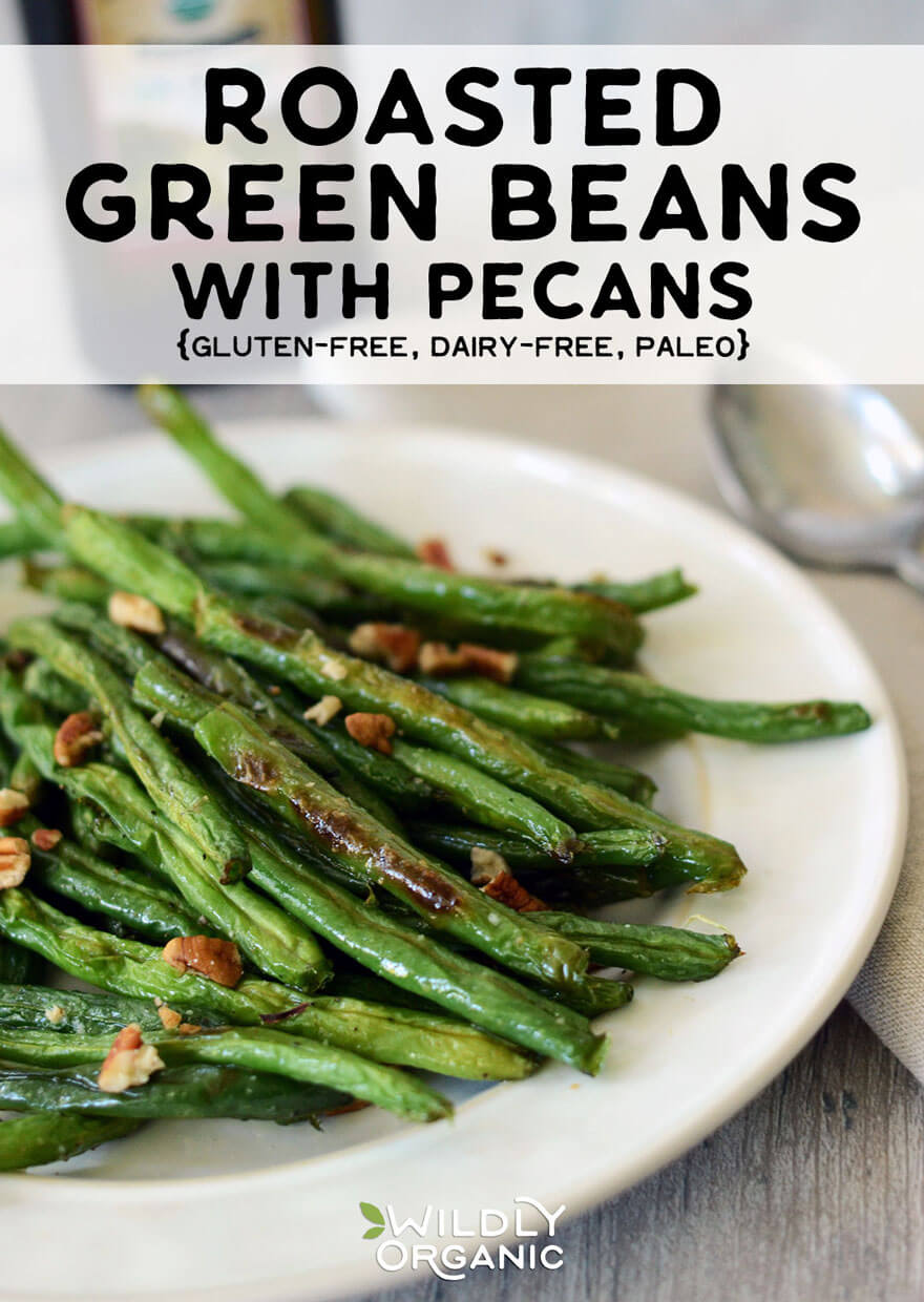 Photo of roasted green beans with pecans on a serving dish.