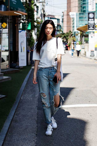 Streetwear outfit with white t-shirt and distressed denim jeans