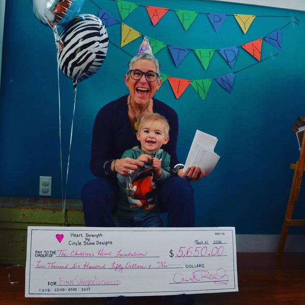 Celebrating Finn's birthday with check to support The Children's Heart Foundation