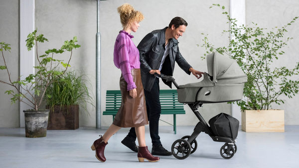 Tall Parents Pushing their Child in a Stroller