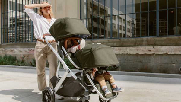 Mom Pushing her Children in a Stroller with a Large Sun Canopy