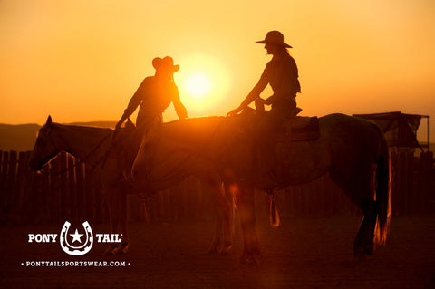 cowgirls on horseback with sunset guest ranch