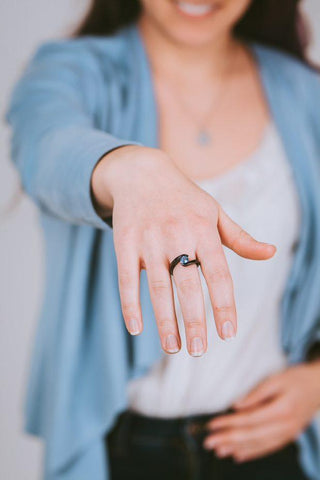 Woman showing off aquamarine titanium ring