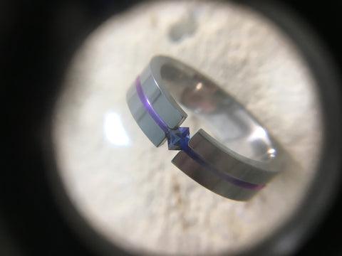 Anodized titanium ring with sapphire gemstone tension setting