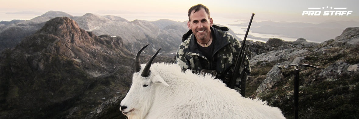 John Nores Jr. on a mountain top with a goat
