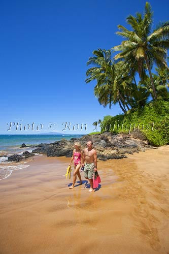 Couple about to go snorkeling at Changs Beach, Makena, Maui, Hawaii Couple about to go snorkeling at Changs Beach, Makena, Maui, Hawaii