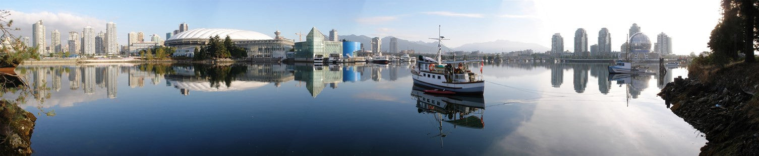 Water view of False Creek in Vancouver with sky and mountains in the back