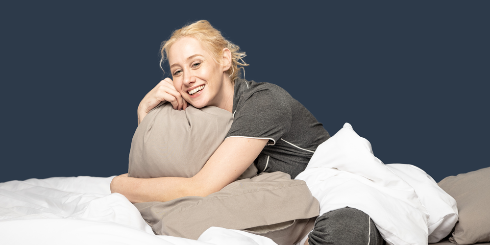 happy-woman-holding-bed-sheets