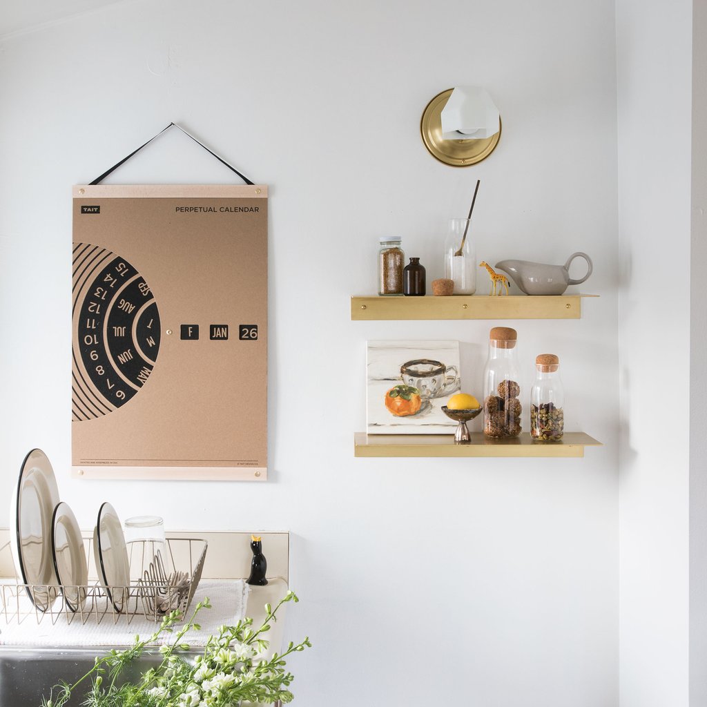 artwork and shelves on a white wall