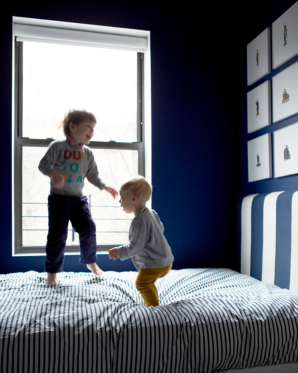 couple of children playing on a bed
