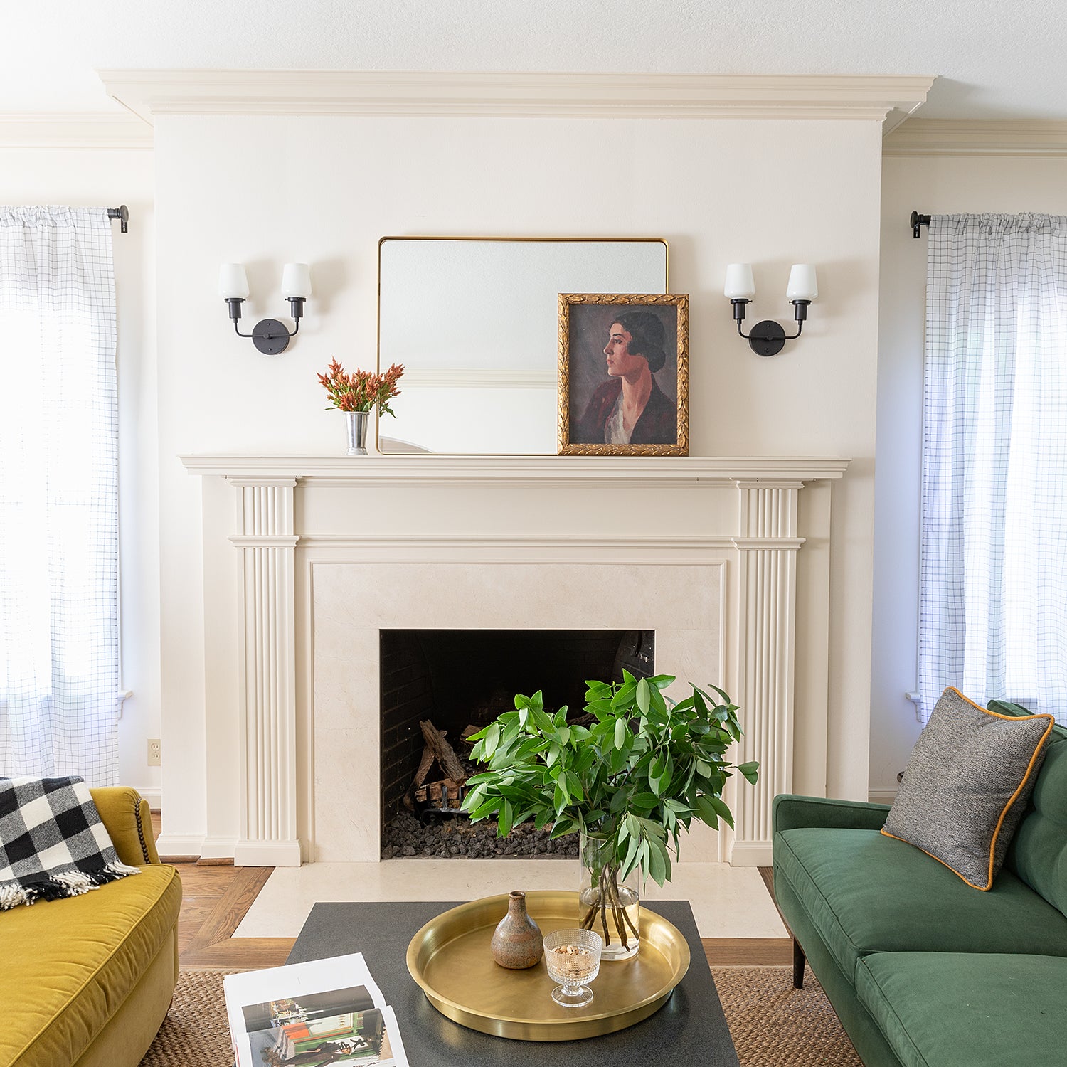 living room with a fireplace and a green couch