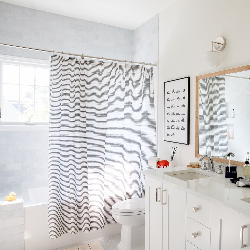 bathroom with a sink and a toilet and shower curtain