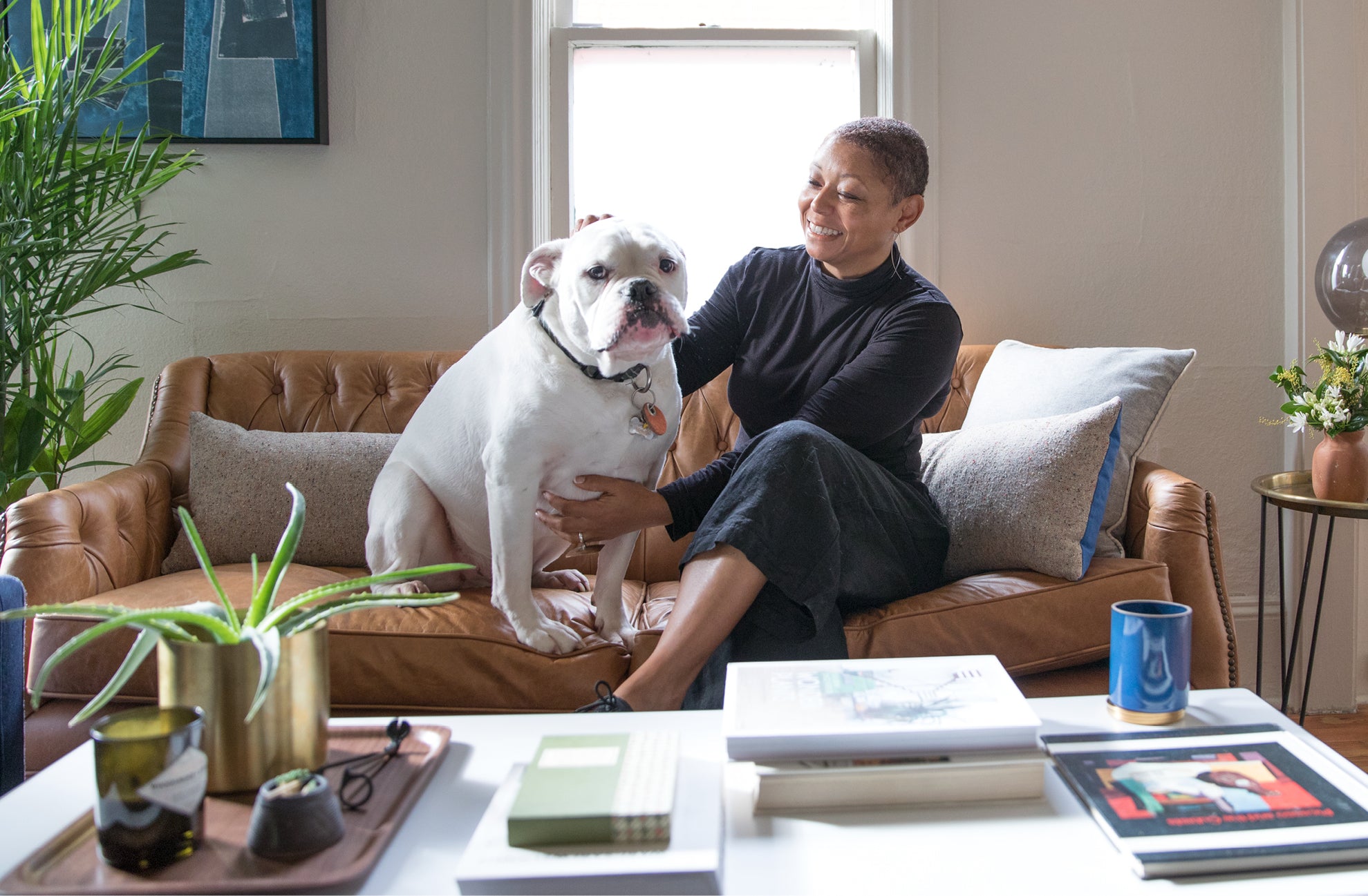 person sitting on a couch with a dog 