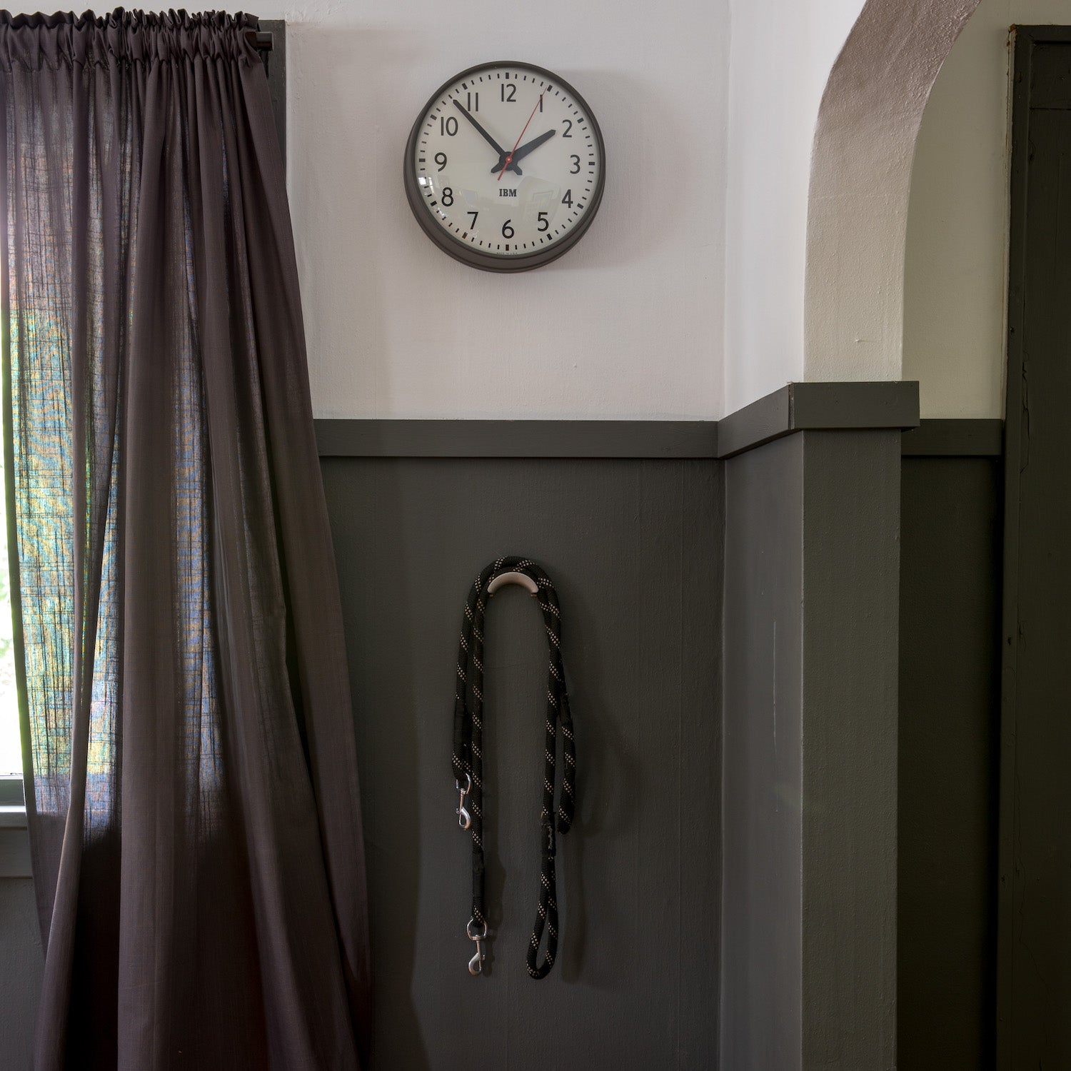 clock hangs from a wall