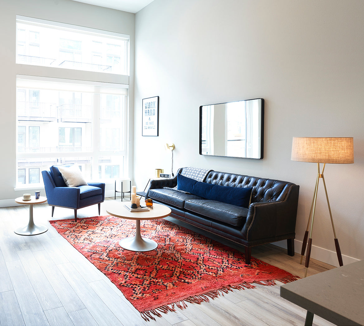 living room with a couch and a table and a red rug