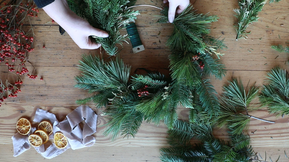 person making a wreath