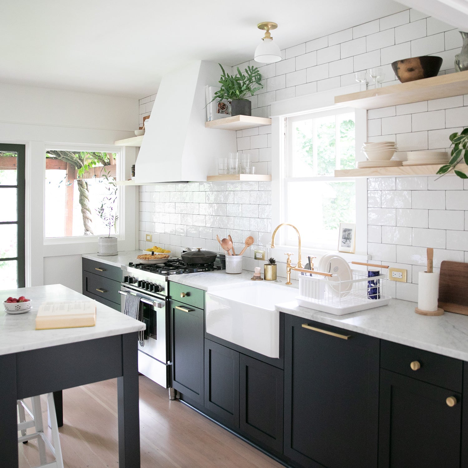  kitchen with black cabinets and light wooden shelves