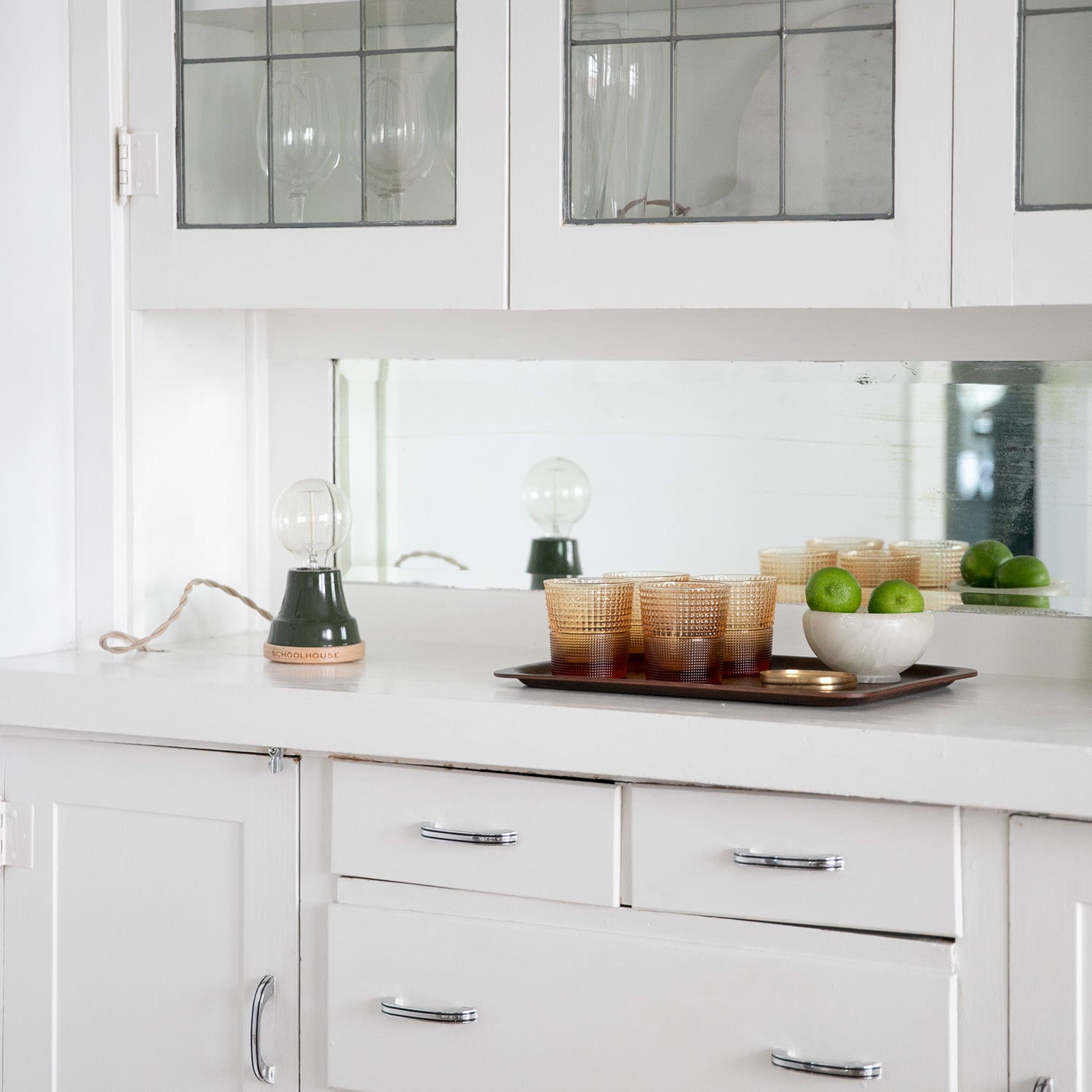 kitchen with white cabinets and a green table lamp 