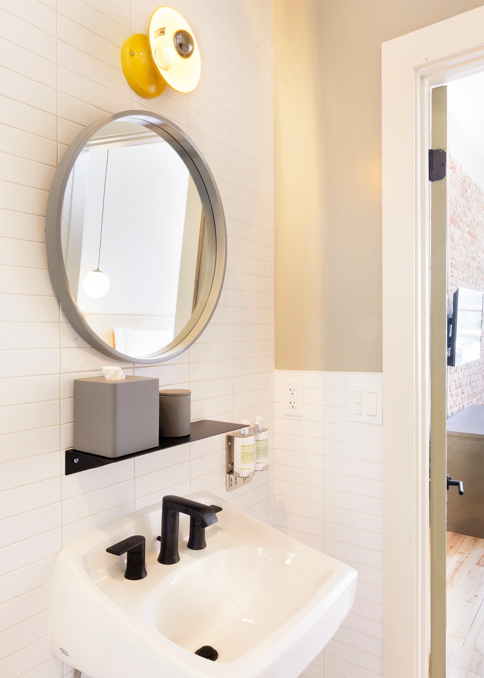 bathroom with a round mirror