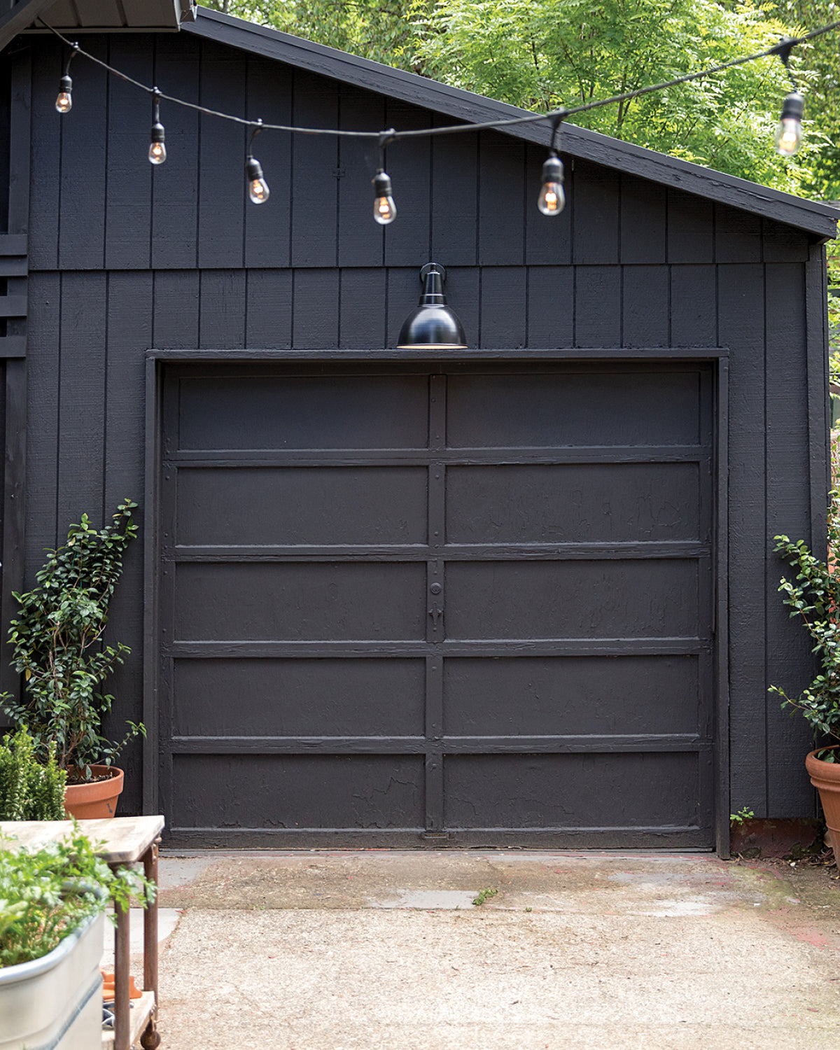 black garage door and string lights