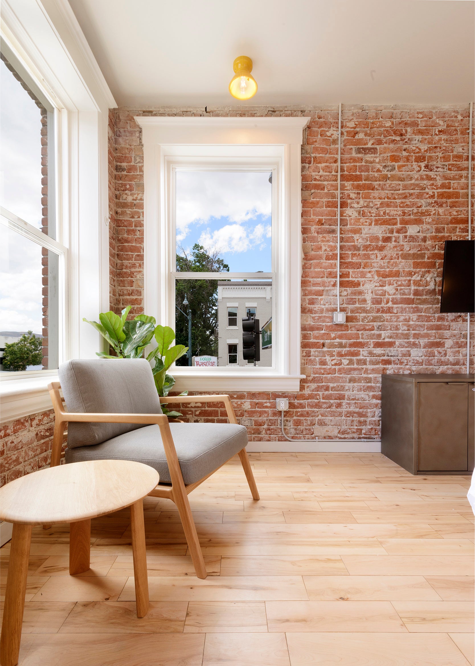 room with brick walls and chairs