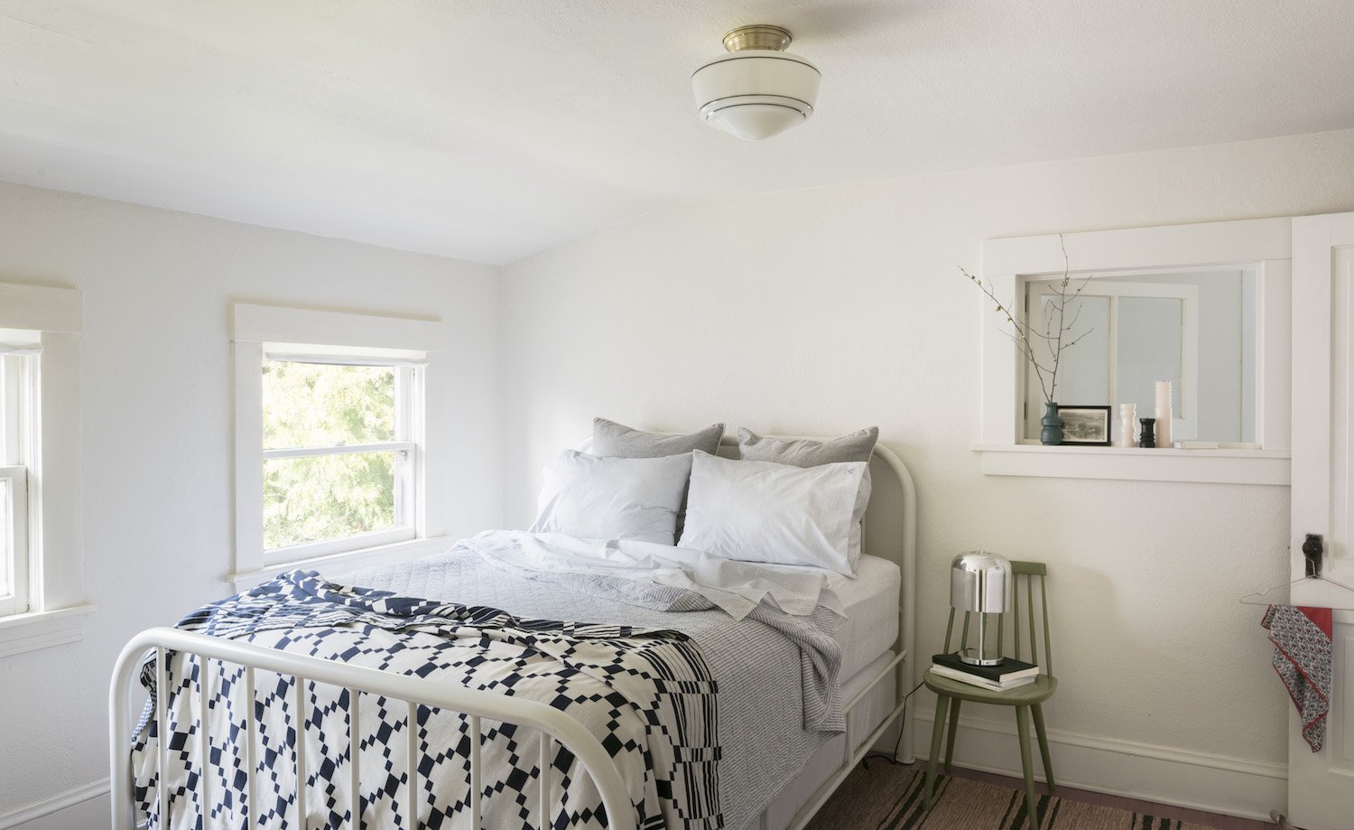 bedroom with a bed and a window and black and white bedspread