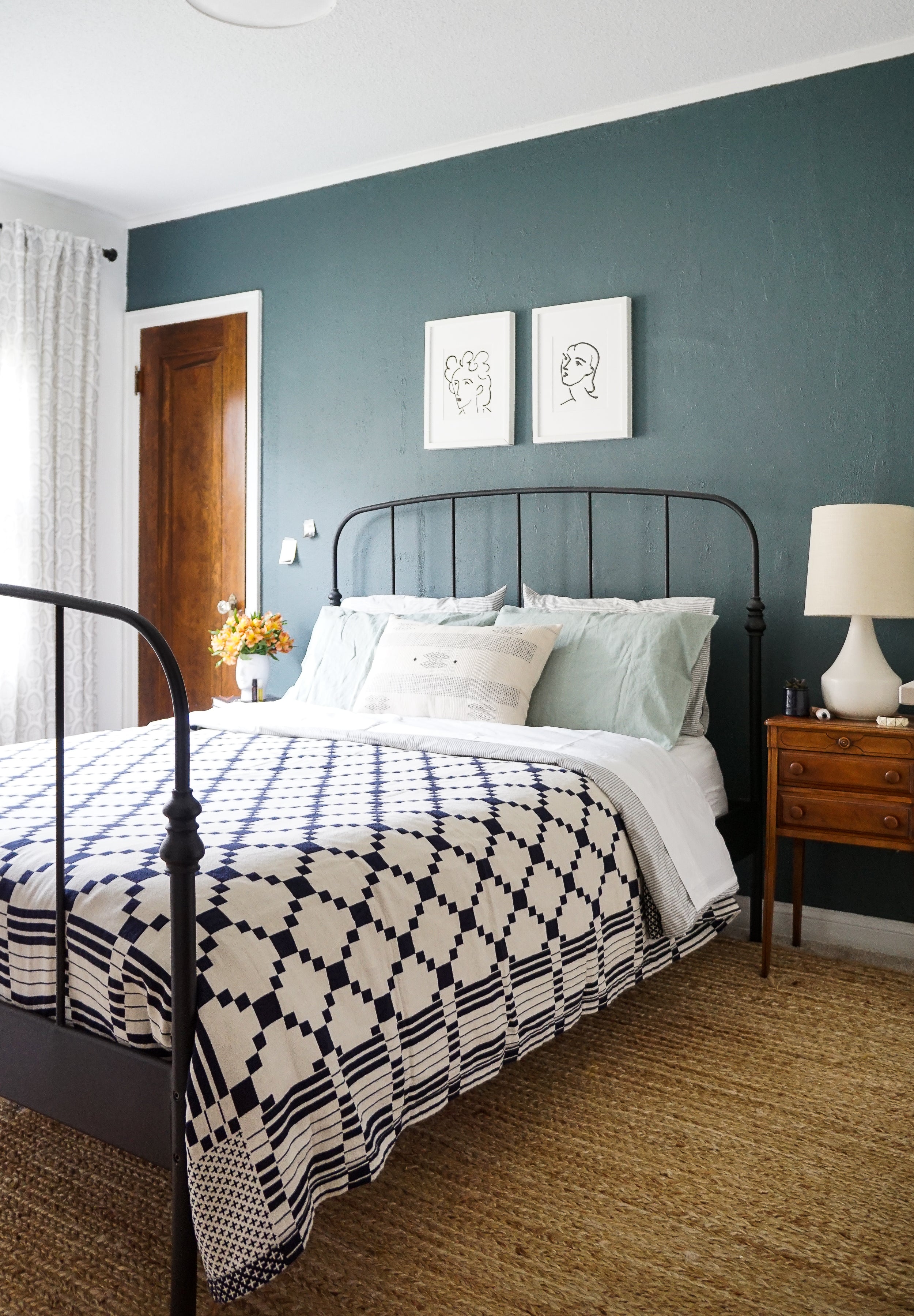 bed with a blue and white comforter and white pillows