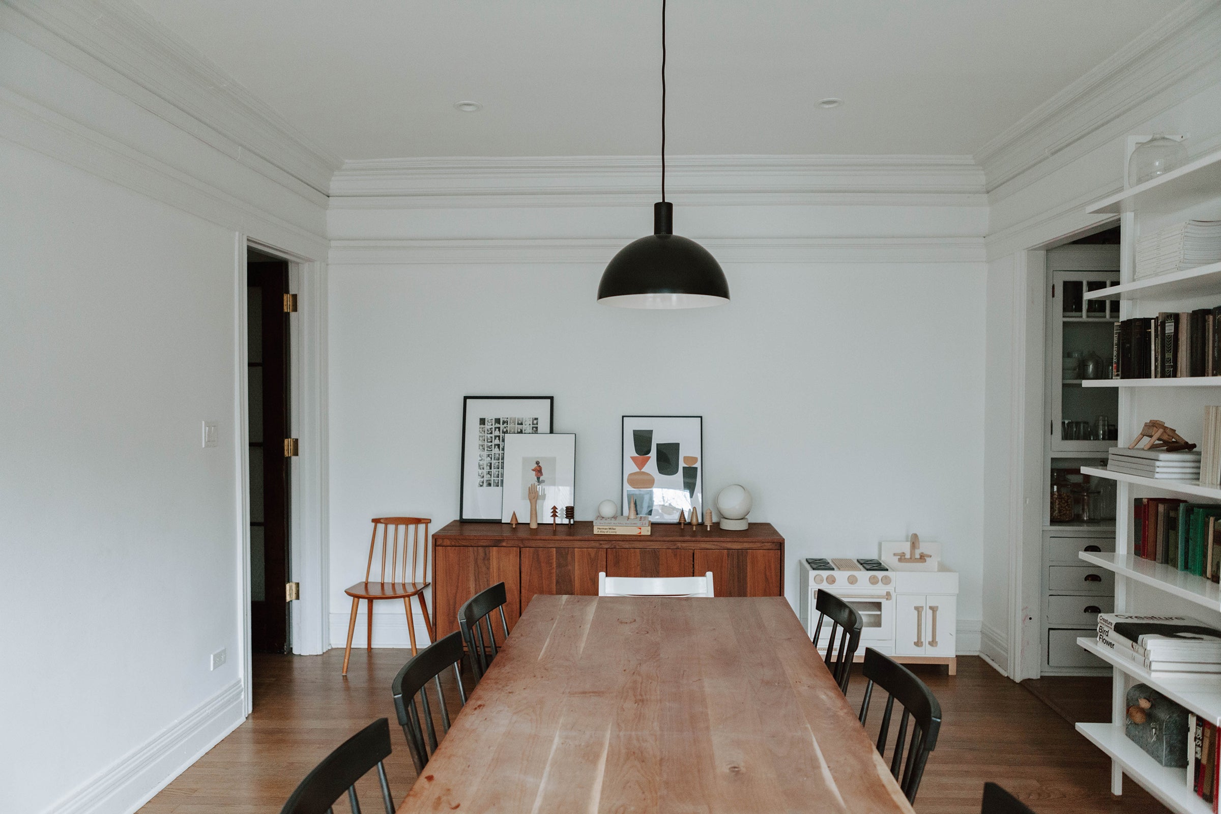dining table in a room and black ceiling light fixture