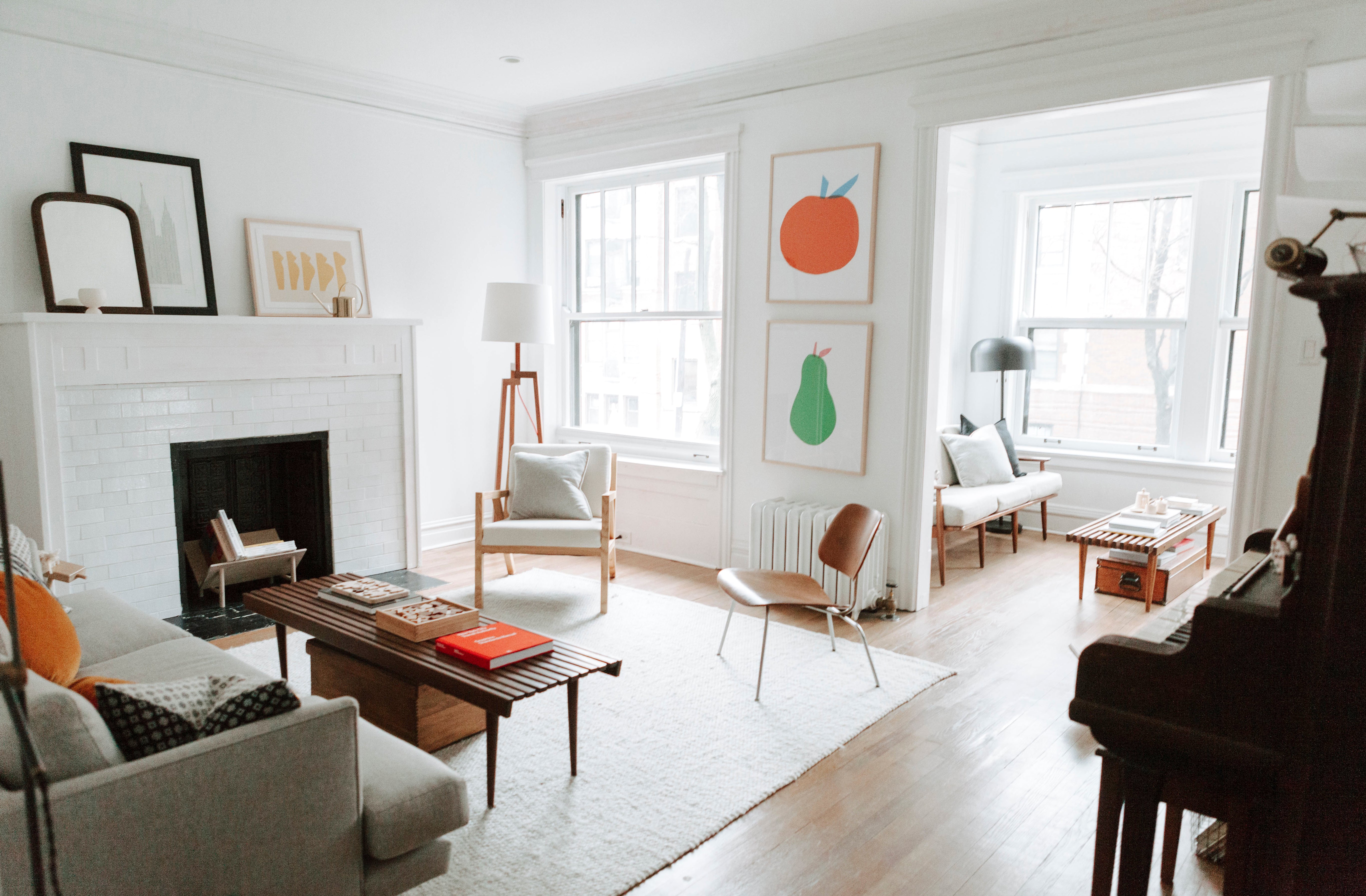 living room with a fireplace and paintings on the wall