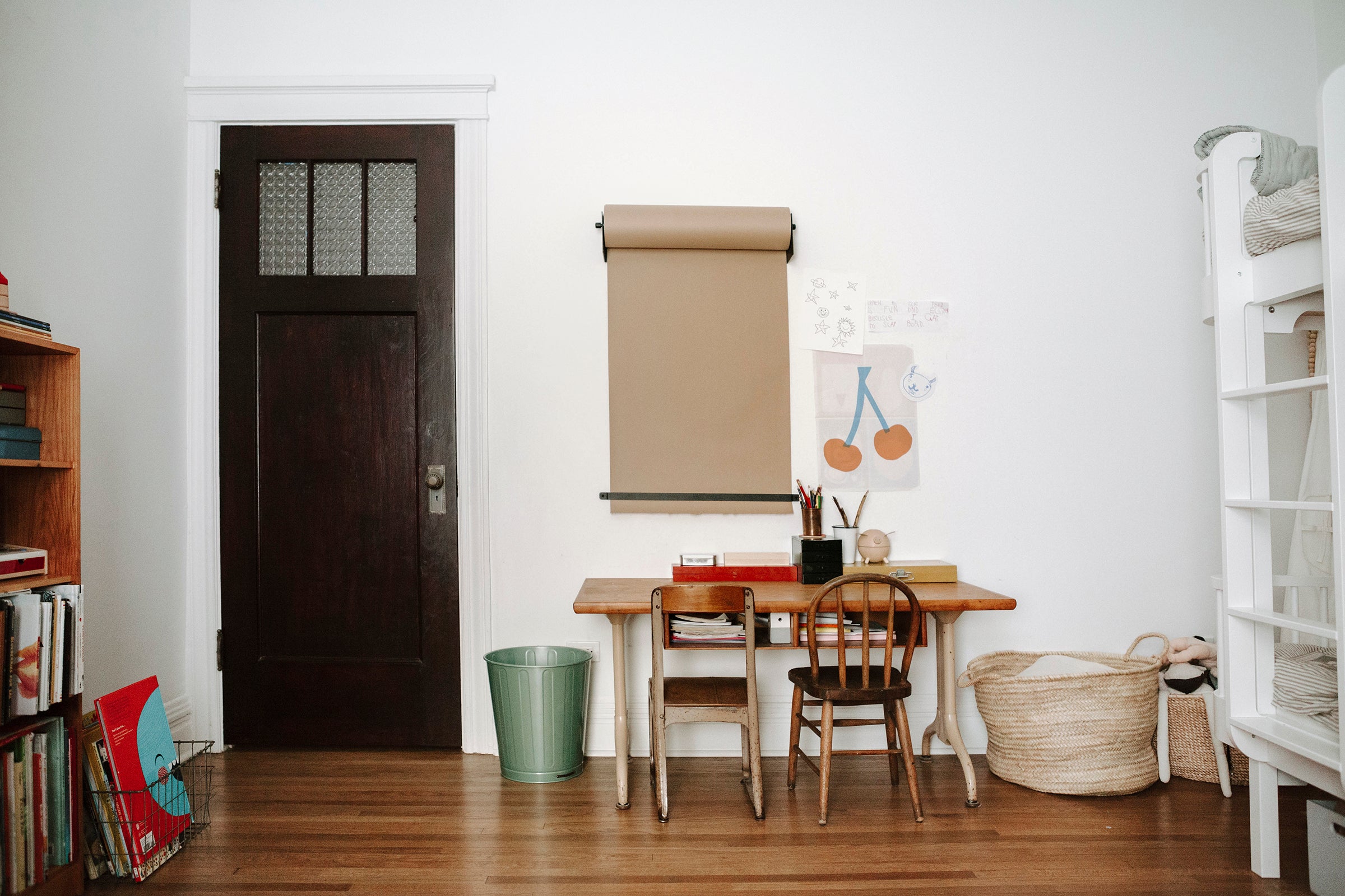 room with a table and chairs and a black door