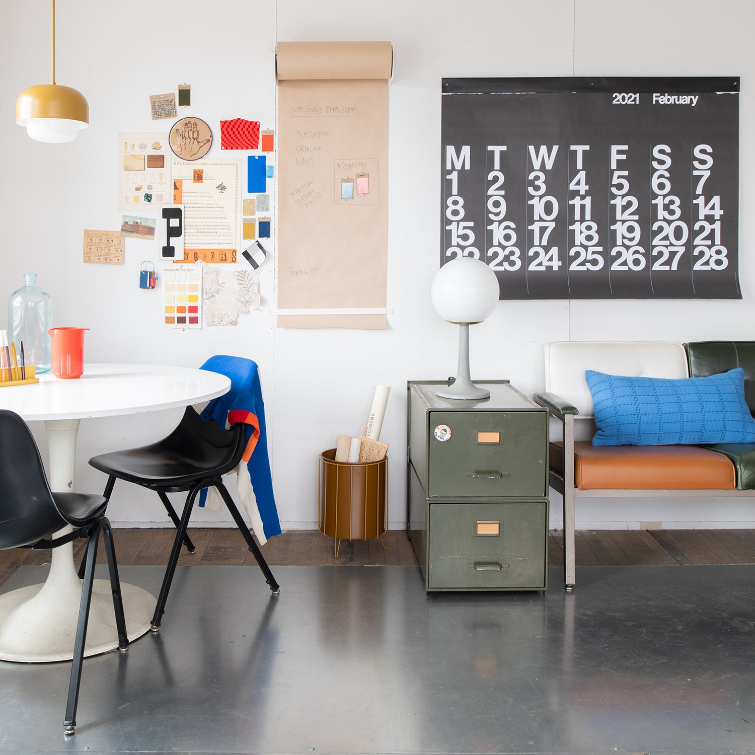 room with a desk and chairs and lamps