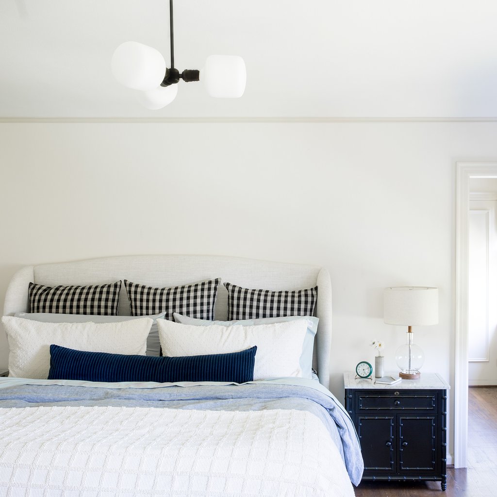 bed with white sheets and blue blanket