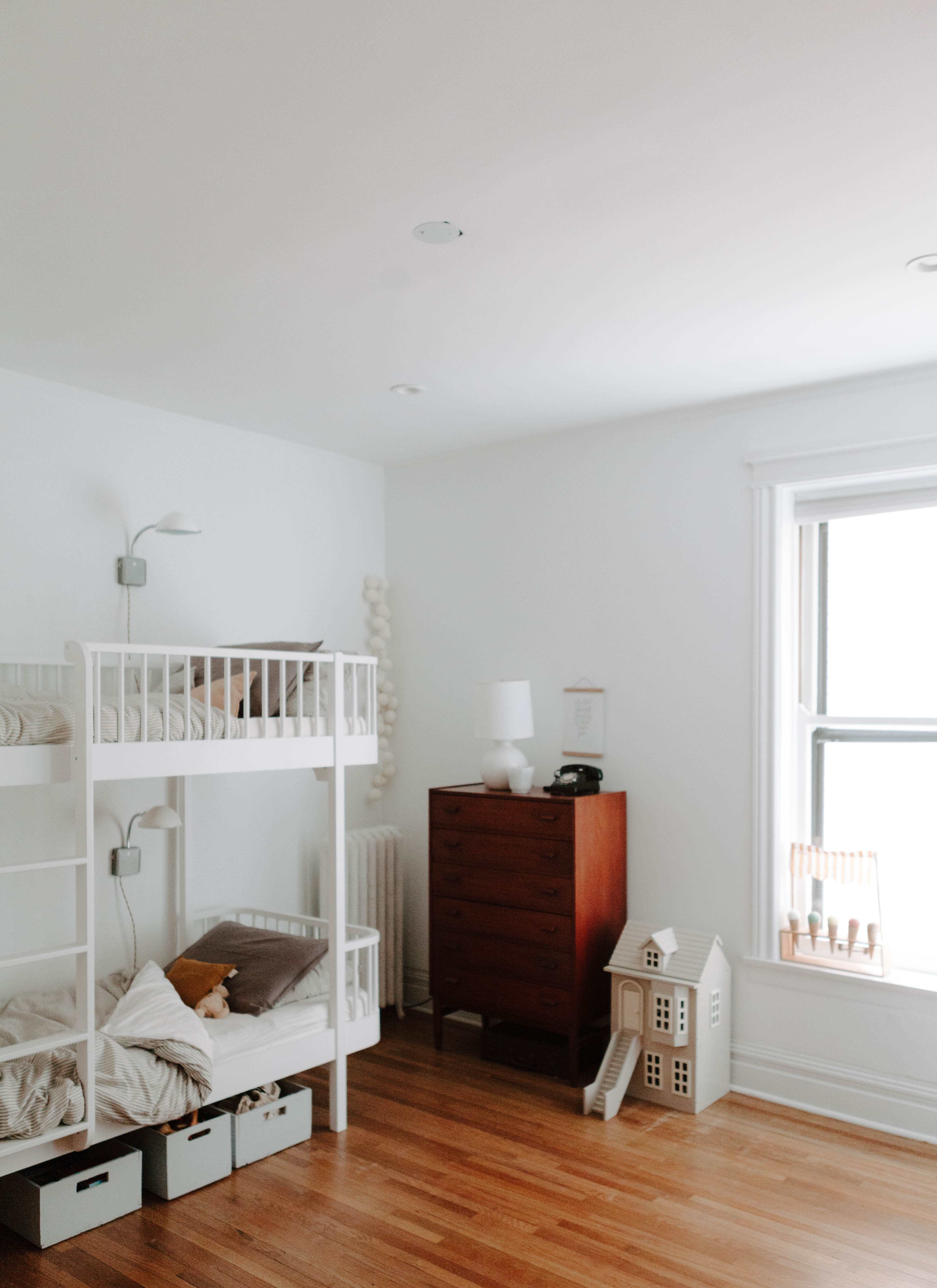 white bunk bed and dress in a white room