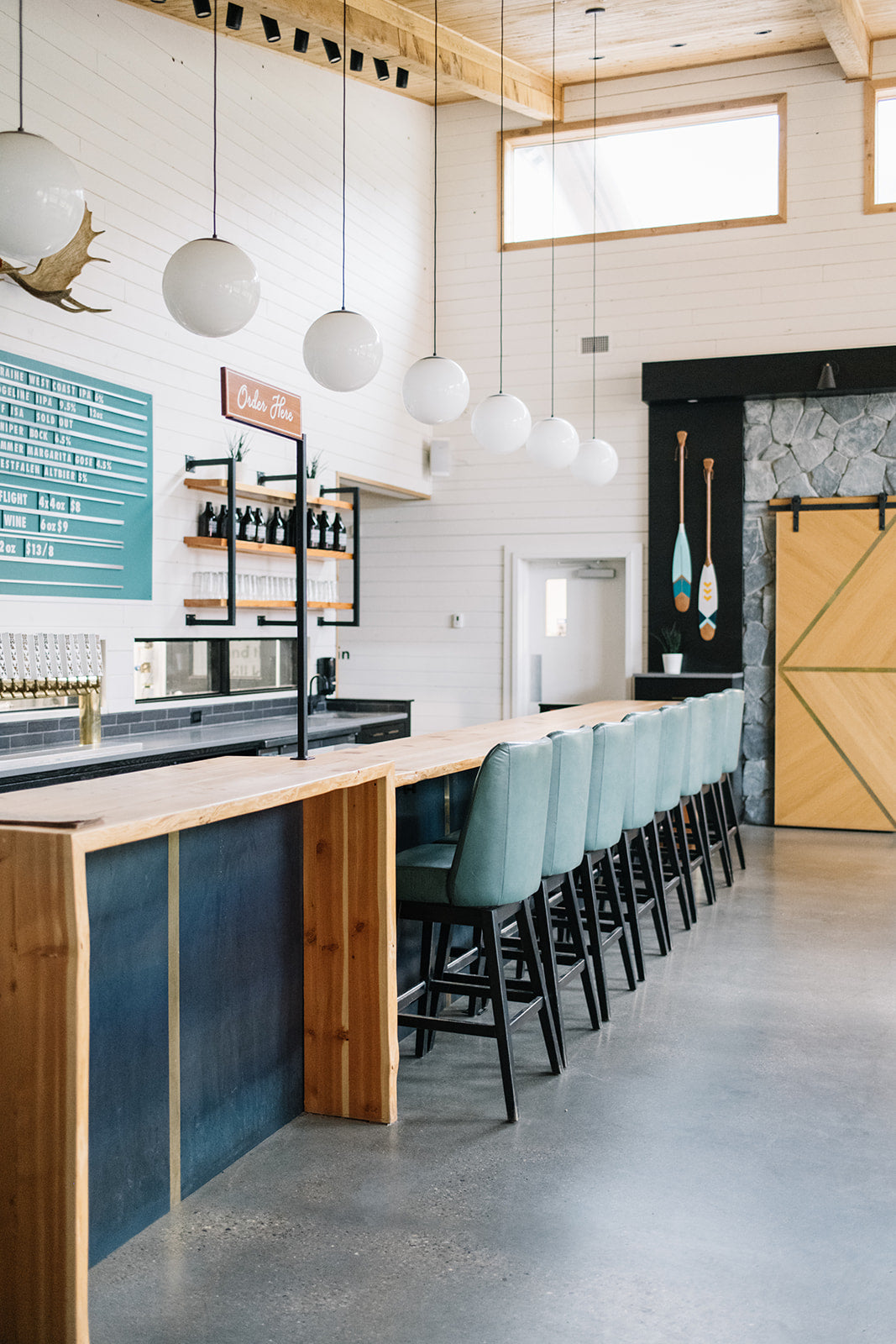 coffee shop with blue chairs and ceiling light fixtures