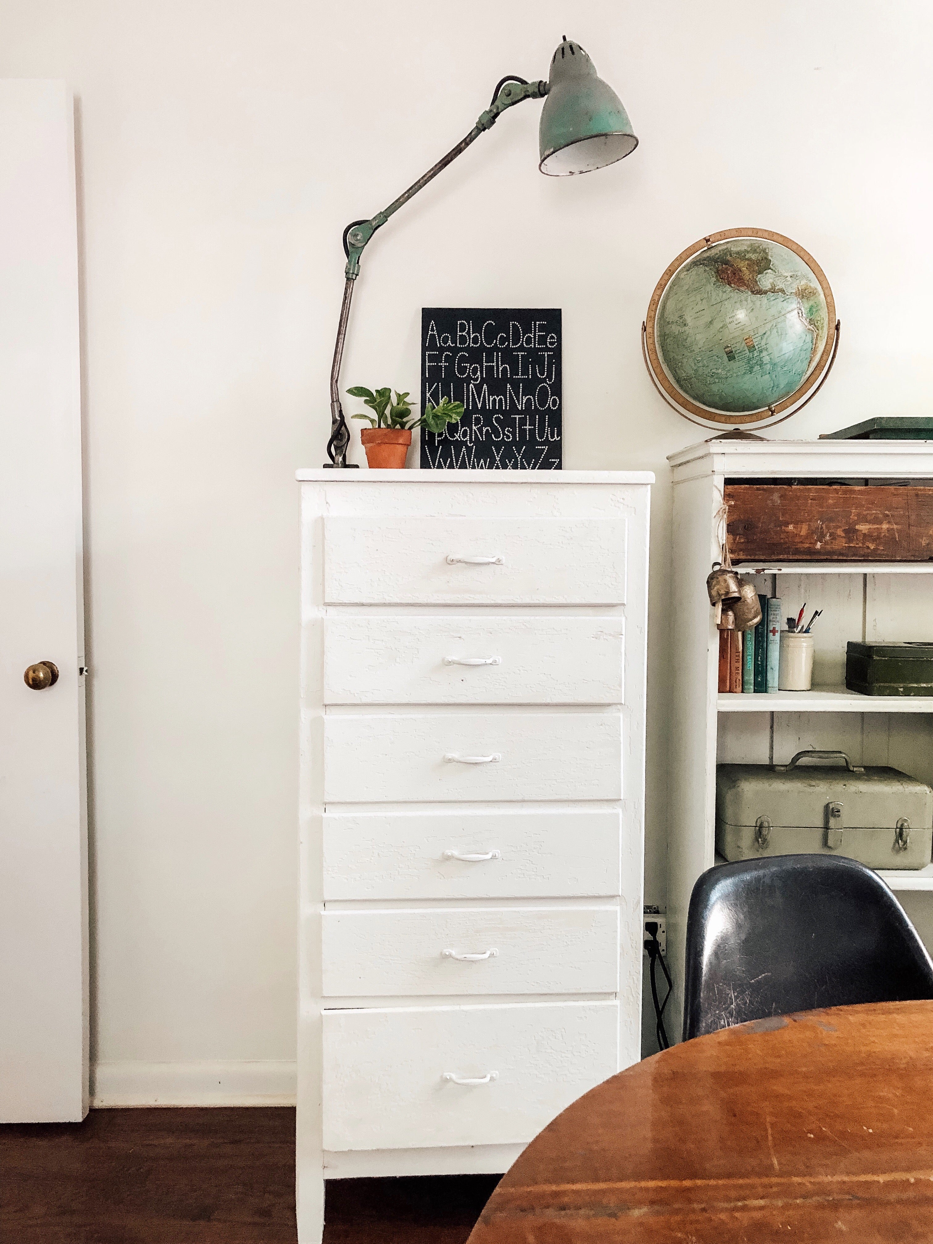 white dresser with a lamp