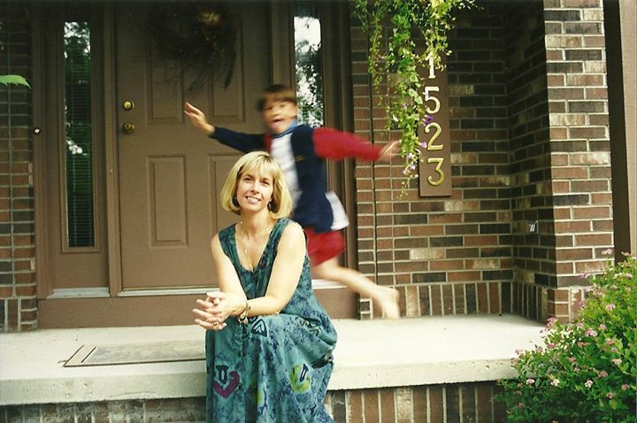 woman and young child posing in front of a house