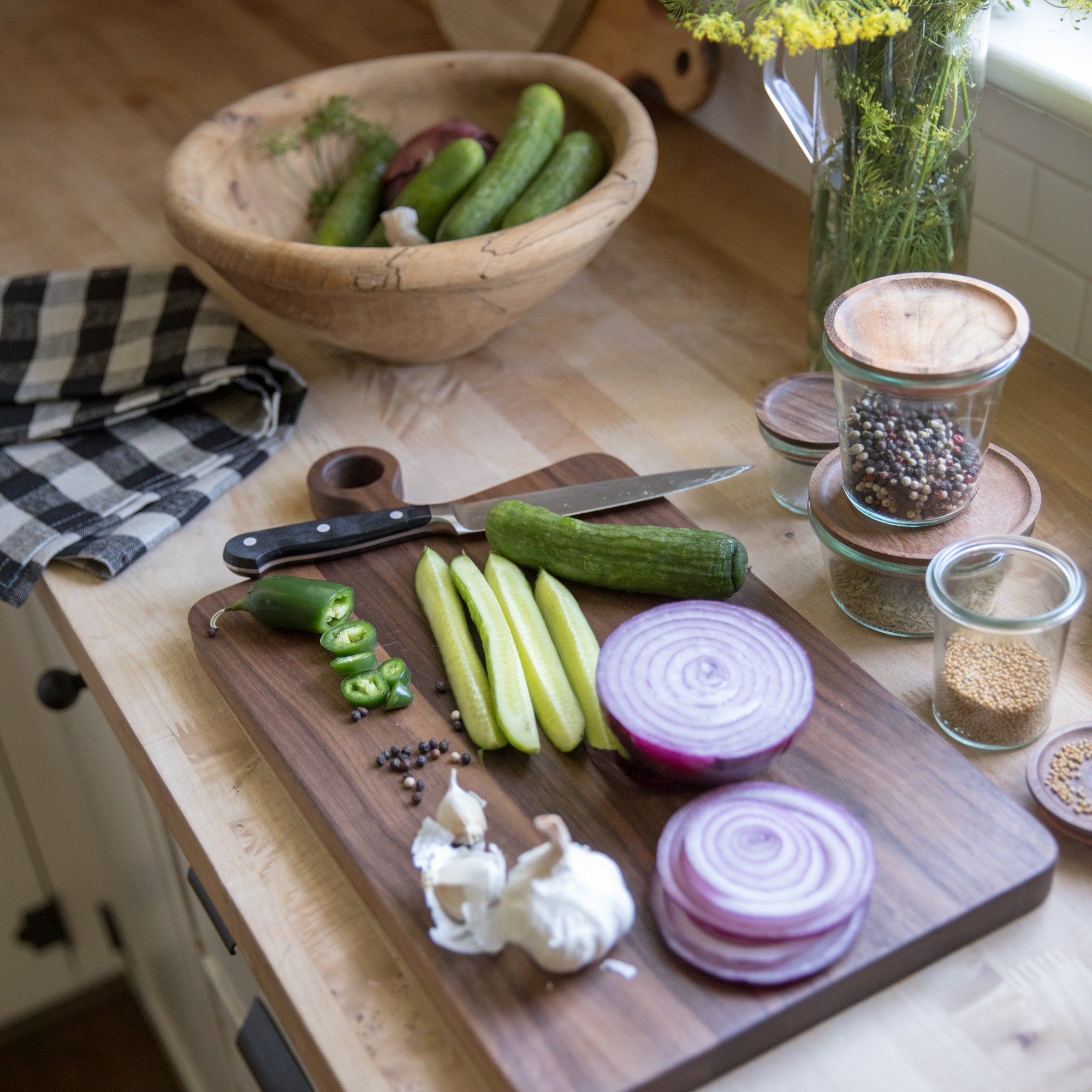 cutting board with vegetables and a knife on it