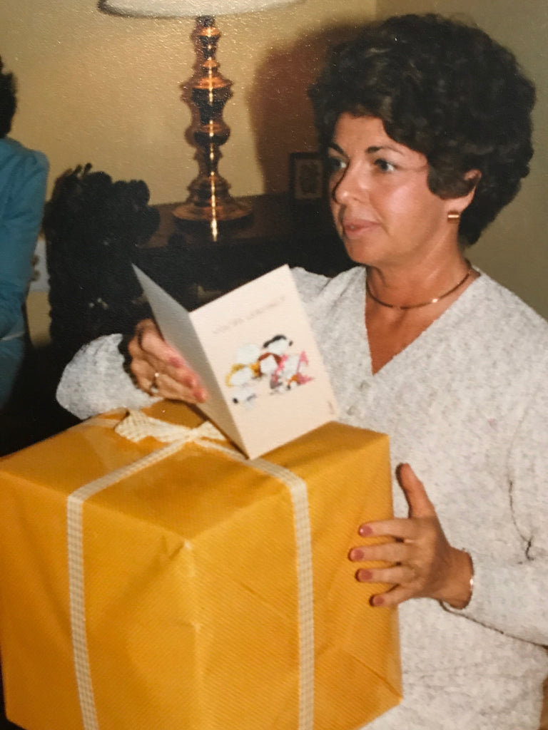 person holding a book and a large yellow present